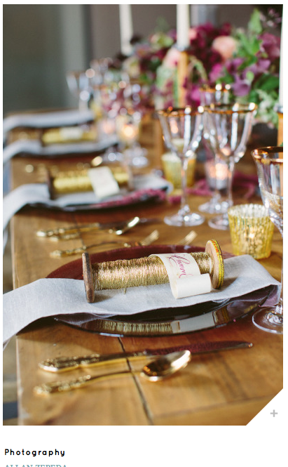 wedding table setting with vintage wooden spools wrapped in golden thread as place cards